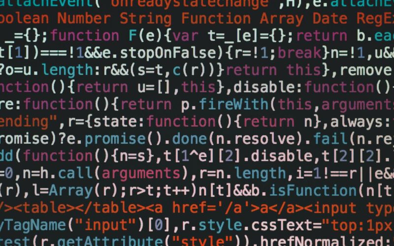 Close-up of colorful coding text on a dark computer screen, representing software development.